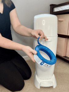 peeling the outer rim off of a diaper genie refill