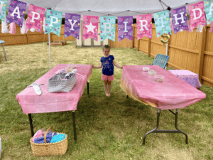 little girl standing with decorated birthday party tables
