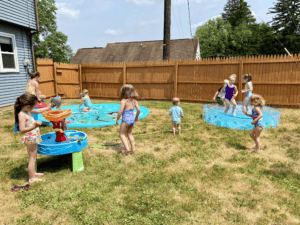 kids playing in a pool, splash pad, and at a water table